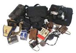 A large collection of cameras and related accessories.