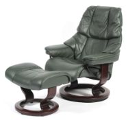A vintage green upholstered Stressless reclining arm chair and matching foot stool.