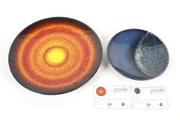 Two limited edition Poole Pottery chargers from the Sun & Moon Collection.