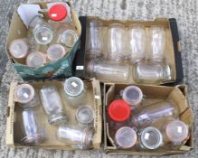 A collection of 24 glass storage jars.