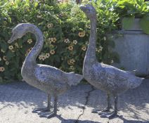 Two large metal figures of geese.