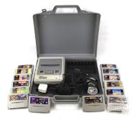 A cased Nintendo Super and assorted games.