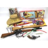 A collection of vintage cowboy cap guns and related items.