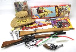 A collection of vintage cowboy cap guns and related items.