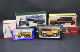 Four boxed diecast vehicles.