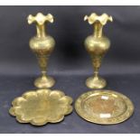 A pair of brass Eastern vases and two circular plates.