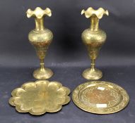 A pair of brass Eastern vases and two circular plates.