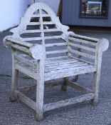 A Lutyens style wooden slatted garden seat.