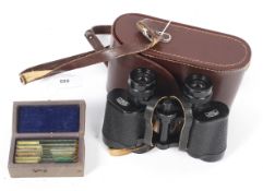 A pair of Carl Zeiss 'Jena' 8x30W binoculars and six microscopic slides.