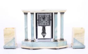 An Art Deco French chome and onyx clock garniture.