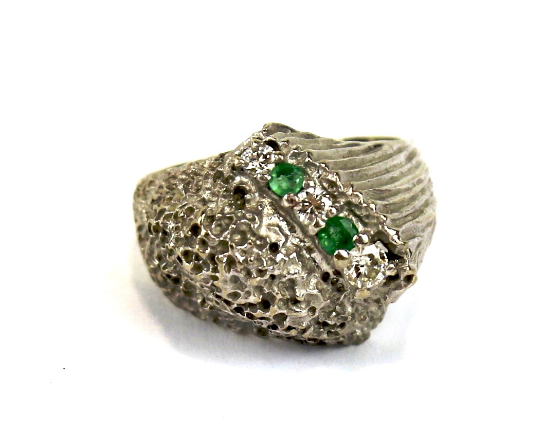 An emerald and diamond dress ring stamped 101c