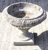 A 20th century reconstituted stone two section urn shaped planter.