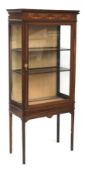 A mahogany glazed cabinet with inlaid decoration. Raised on slender square supports.