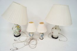 A Pair of oriental style table lamps. and a pair of Delft style all with shades. H68cm.