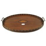 An Edwardian mahogany and string inlaid oval butlers tea tray.