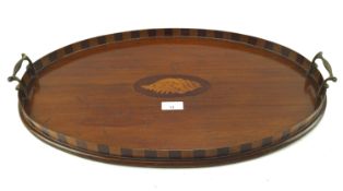 An Edwardian mahogany and string inlaid oval butlers tea tray.