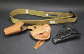 Three leather gun holsters.