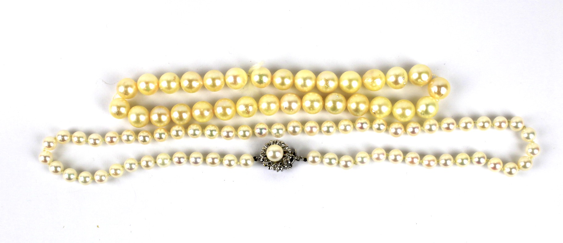A continental white gold clasped string of pearls and another.