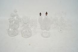 An assortment of crystal glassware. Including 4 decanters, shot glasses, tumblers etc.