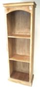 A limed pine open bookcase with two shelves.