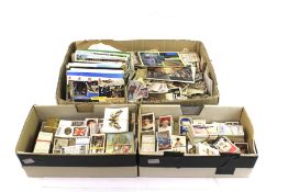 A large collection of cigarette cards and postcards.