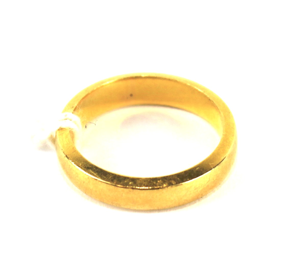 A 22ct gold wedding band. UK ring size L,