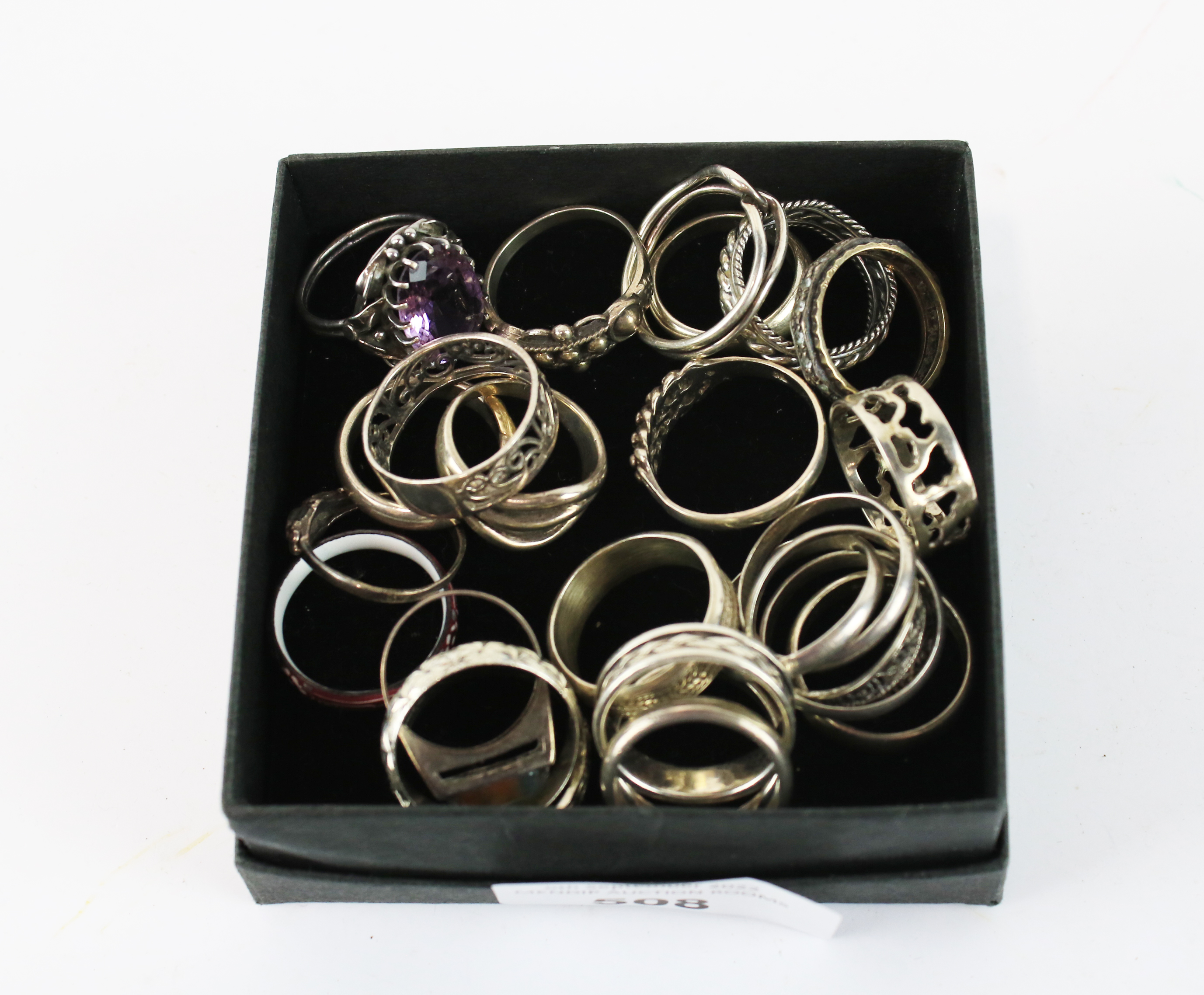 A collection of silver and white metal rings.