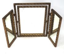 A gilt decorated tryptic mirror with rope twist decoration to the frame.