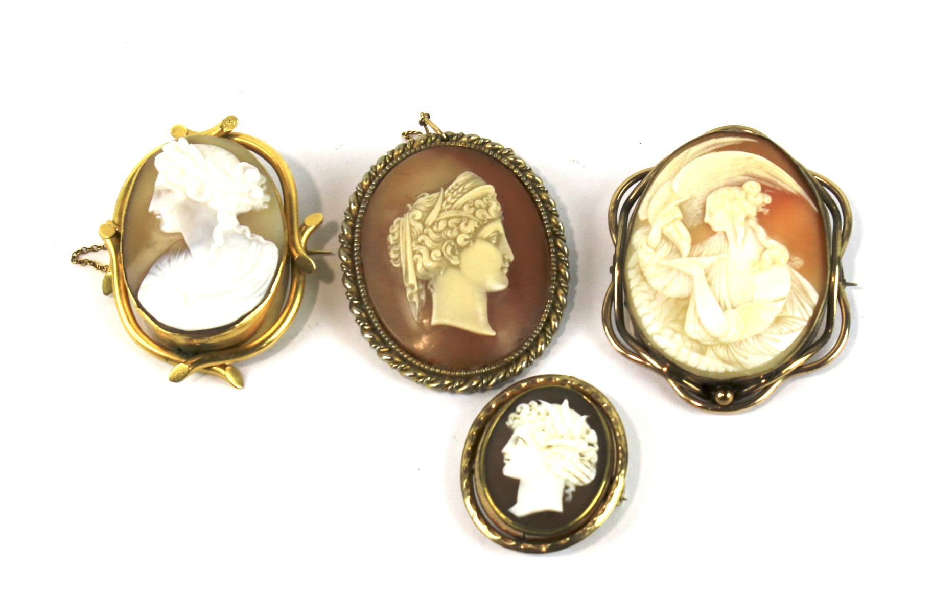 Four Victorian gilt metal and shell cameo oval brooches.