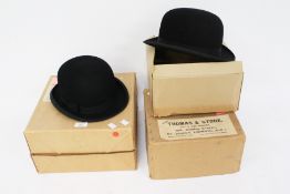 Two black bowler hats. One by G.A.