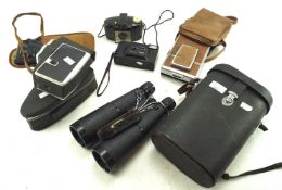 An assortment of cameras and binoculars, To include a Polaroid SX-70 land camera,