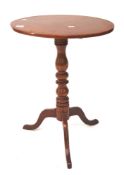 A Victorian walnut tripod table.