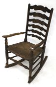 A stained oak ladderback rocking chair.