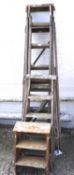 An assortment of vintage wooden ladders.