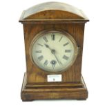 A stained oak cased mantel clock.