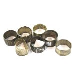 Four silver and four silver plated napkin rings.