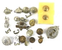 An assortment of military badges and buttons.
