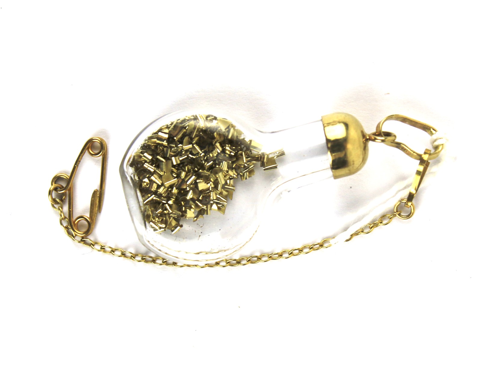A pendant in the form of a glass flagon with gold shavings