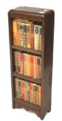 A 20th century oak bookcase with books.