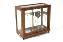 A cased set of Griffin & George Ltd scales. Set in a glass case complete with weights.