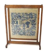 A early 20th century oak framed fire screen.