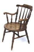 A Swedish Ibex elm penny carver elbow chair. On turned supports and stretchers.
