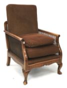 An early 20th century bergere chair raised on cabriole supports.