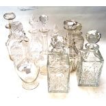 An assortment of cut and other glass decanters.