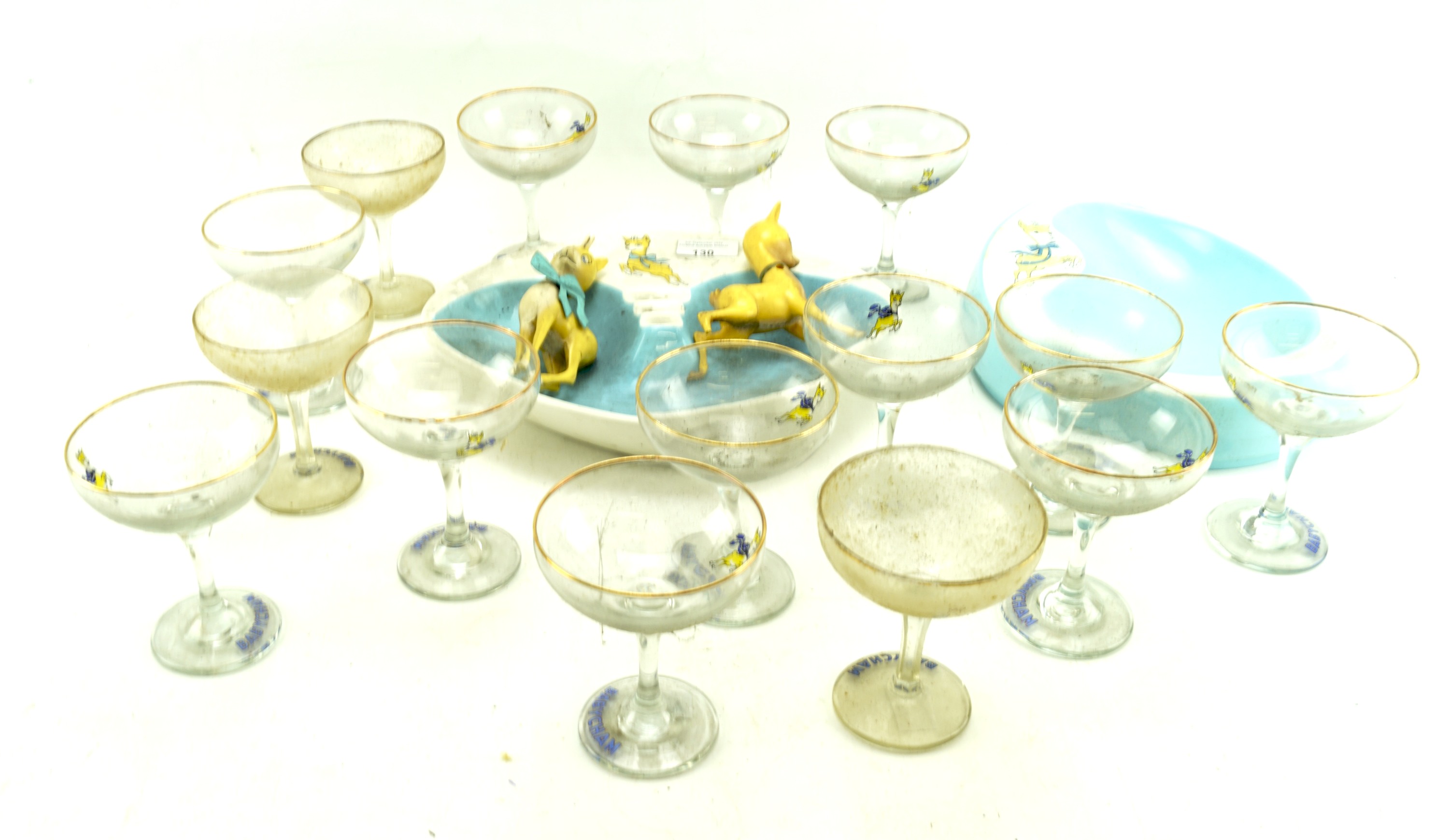 Fifteen Babycham glasses and two ashtrays.