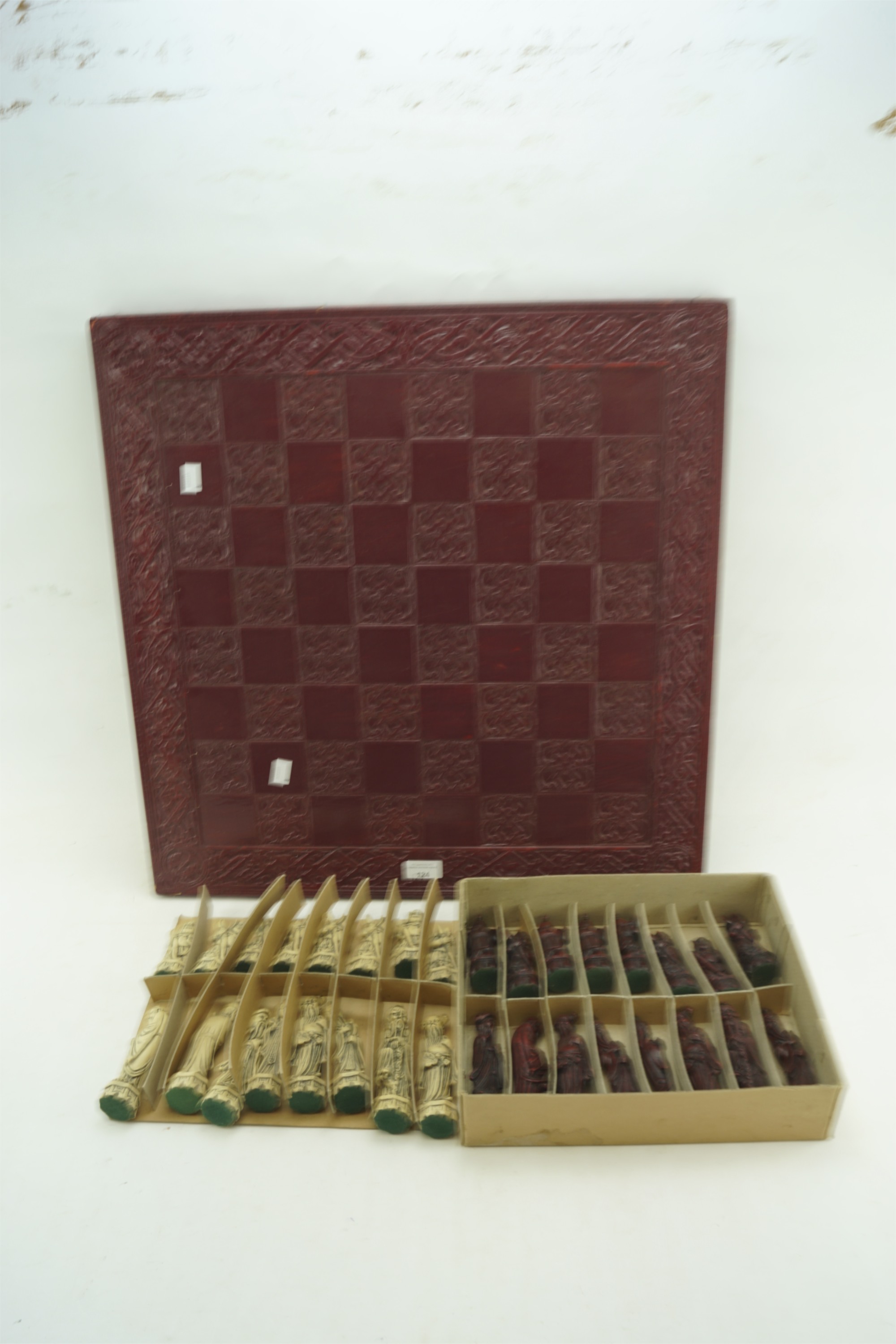 A 20th century resin Chinese chess set with chess board.