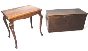 A stained wooden storage trunk and a mahogany side table.