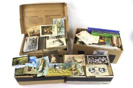 Four boxes of postcards and related items.
