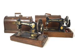 Two late 19th, early 20th century Singer sewing machines in fitted carry cases