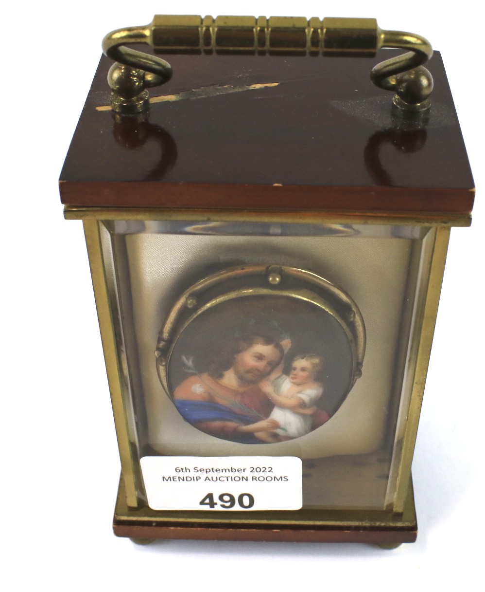 A yellow metal mounted painted porcelain brooch depicting a religious scene.